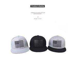 Detail of three snapback hats in grey, black and contrast colors with flag embroidery