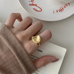 Detailed close-up of a golden S925 silver irregular lava ring worn on a finger