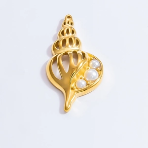 Detailed view of a hollow golden conch pendant set with three white pearls on white background