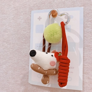 Handmade fabric puppy keychain with green pompom and red rope on a heart clasp
