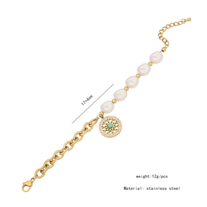 Detail of stainless steel bracelet with irregular pearls and blue stone mandala charm