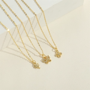 Three gold necklaces set with butterfly and flower pendants featuring white zircon stones