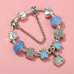 Detailed view of silver charm bracelet with cat paw pendants and my best friend tag