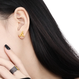 Elegant gold twig stud earrings with rhinestones for women in a studio close-up view