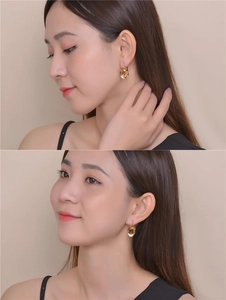 Detail view of oval yellow zircon earrings worn by a model in a minimalist style