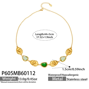 Detail of stainless steel gold chain necklace with green crystals and hammered pendants