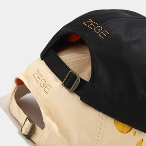 Close-up of ZEGE embroidery and adjustable metal buckle on cotton baseball caps