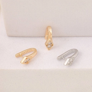 Macro detail of gold and silver cubic zirconia flower pendant bails for DIY jewelry