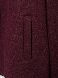 Macro detail of a straight pocket on a burgundy wool blend vintage casual jacket
