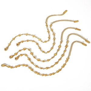 18k gold plated stainless steel bracelet set with cross and heart charms on white background