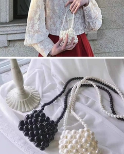 Detail of handcrafted mini pearl crossbody bag with beaded strap in black and white