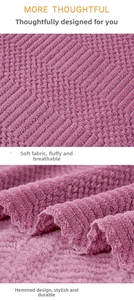 Close-up of purple coral fleece towel showing wavy texture and durable hemmed edges