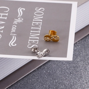Detailed view of silver and gold infinity stud earrings with sparkling crystal inlay