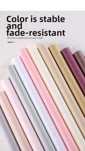 Macro shot of colorful pearlescent wrapping paper rolls in pink, grey, and purple tones