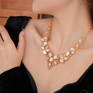 Elegant gold necklace with floral rhinestone crystals shown on model for bride party