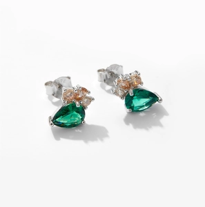 Detail of 925 silver stud earrings with green teardrop stones and S925 hallmark
