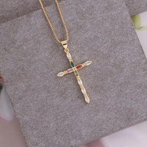 Detailed view of 18K gold cross pendant with colorful marquise zircons and box chain