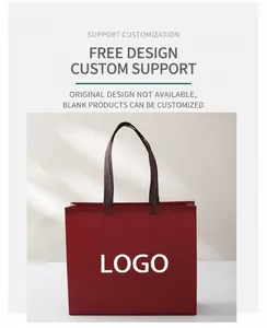 Detail of burgundy non-woven tote bag with black handles showing custom logo print area