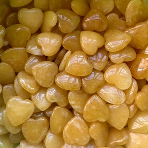 Close-up macro of bulk polished heart-shaped yellow quartz crystals for home decoration