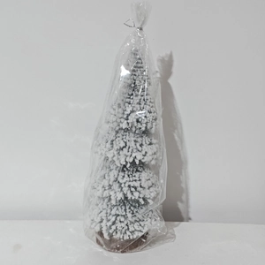 Mini snowy Christmas tree detail showing white flocking texture and round wooden base