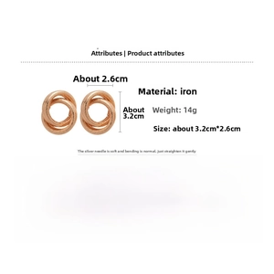 Detail view of interlocking rose gold metal knot earrings with silver needle specs
