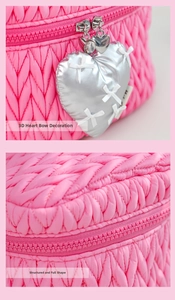 Detail of pink quilted makeup bag with 3D heart charms and sturdy box-shaped structure