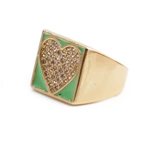 Detail of gold heart ring with green enamel accents and shimmering crystal stones