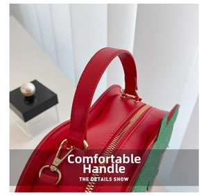Detailed close-up of the red leather strawberry bag handle with golden metal zipper
