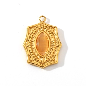 Close-up of a vintage 18K gold pendant featuring an oval orange stone and zircon inlay