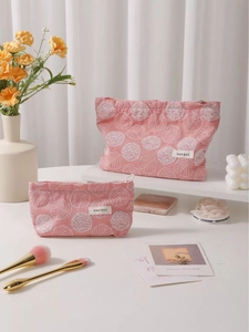 Set of two pink floral embroidered linen makeup bags with zipper and brand label