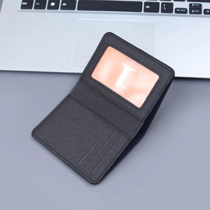 Vertical minimalist black canvas wallet with multi-card slots and clear ID window view