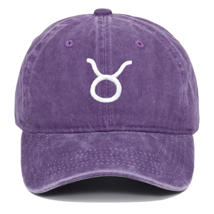 Close-up of Taurus zodiac embroidery on purple washed cotton baseball cap with ventilation eyelets