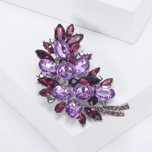 Detailed close-up of crystal flower brooch with purple rhinestones on silver alloy