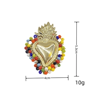Detailed view of handmade beaded sacred heart pendant measuring 5.3cm high and 4cm wide