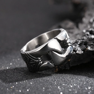 Macro shot of wide industrial titanium steel ring with vintage embossed textures