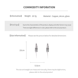 Détails techniques des boucles d'oreilles pompons de 10 cm en cuivre, zircon et verre