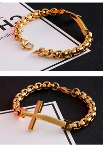 Detail view of a polished gold cross and durable stainless steel box chain for men