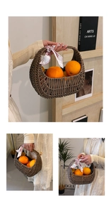 Detailed view of a brown woven basket bag with a pink ribbon handle and fresh oranges inside