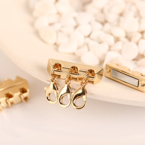 Macro shot of 18K gold plated multi-layer magnetic necklace clasp with lobster buckles