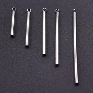 Detailed view of silver stainless steel cylindrical bar pendants in various lengths