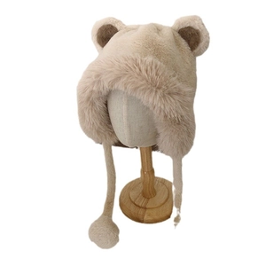 Cute beige plush bear ear hat with earflaps and pom-poms for winter outdoor warmth