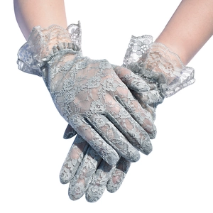 Close-up of light grey floral lace gloves with ruffled cuffs and delicate mesh embroidery