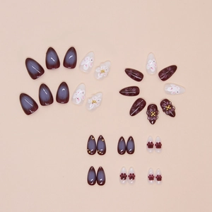 Almond-shaped press-on nails with 3D white flowers, cat paw prints and purple gradient
