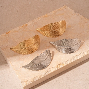 Set of 4 gold and silver metal feather earrings with detailed embossed texture