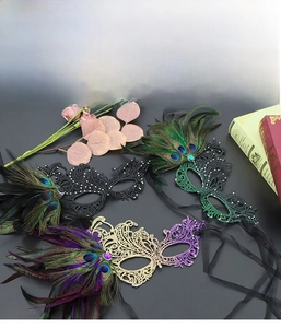 Detailed view of luxury lace masquerade masks with feathers and rhinestones in various colors