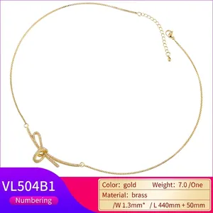 Elegant gold-tone brass ribbon bow necklace with micro-paved cubic zirconia accents