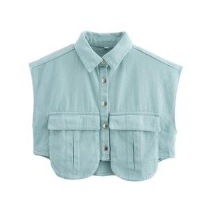 Détail du gilet en jean bleu clair montrant le col à revers et les boutons métalliques