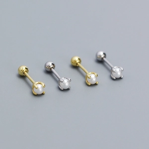 Macro view of gold and silver S925 sterling silver pearl stud earrings with screw back