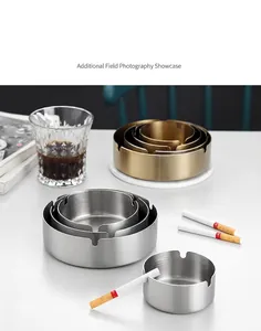 Stack of gold and silver stainless steel ashtrays with brushed finish and three cigarette slots