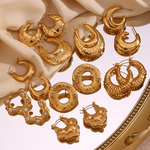 Detail of 18K gold-plated vintage earrings with geometric cutout and hammered textures